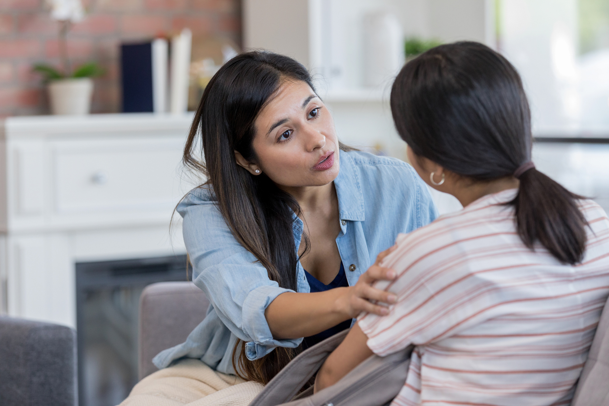 Mid adult mother talks to teen daughter